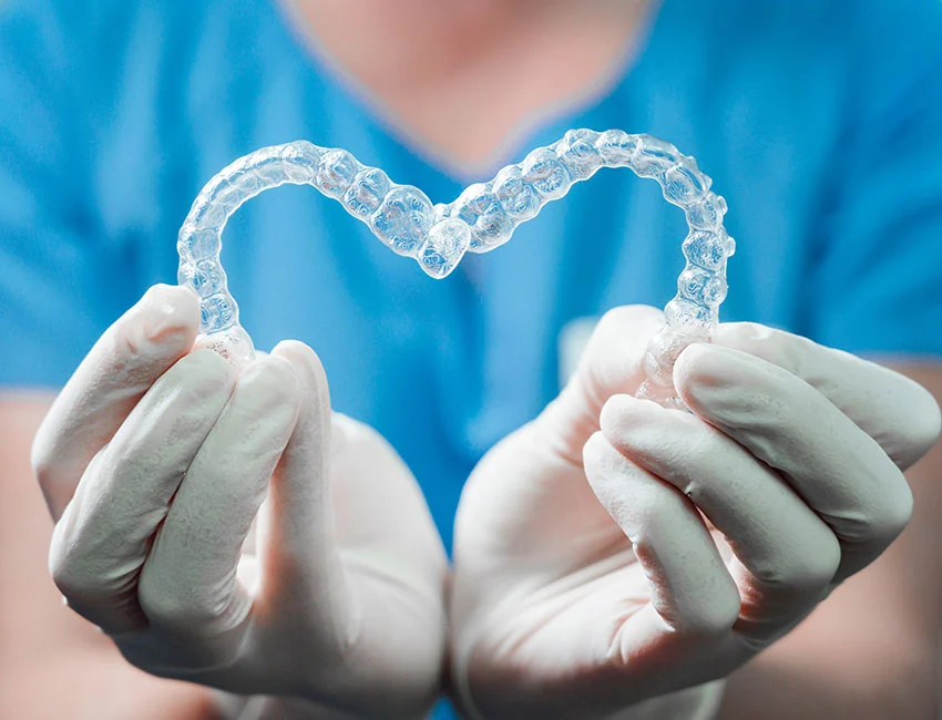 Orthodontist Holding Invisalign clear aligners